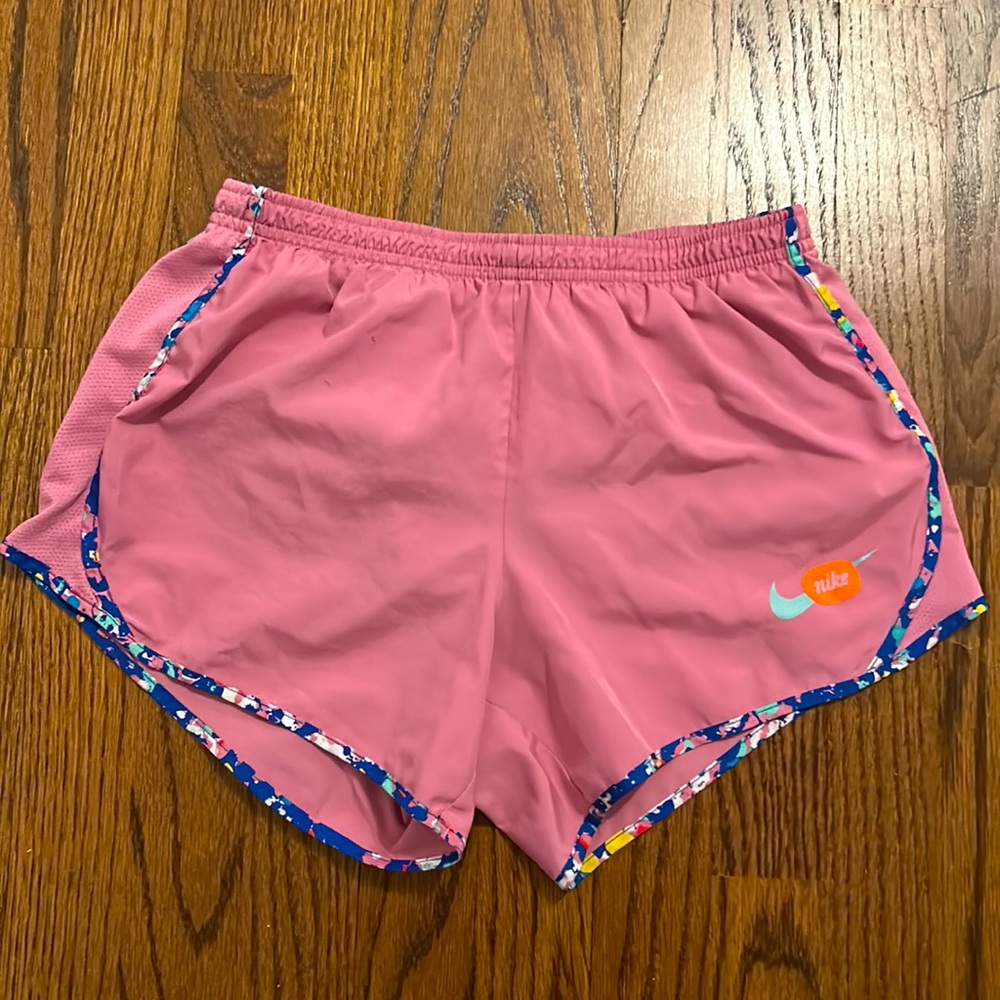 Nike pink shorts with colorful trim.